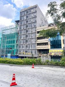 a large building with two red cones in front of it at Hotel Aman Kuala Lumpur in Kuala Lumpur