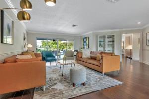 a living room with two couches and a table at Waterfront Oasis w/ Pool Minutes to Downtown! in Boynton Beach