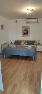 a large bed in a room with a wooden floor at Apartments Aleksandra in Crikvenica