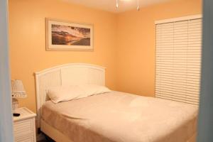 a bedroom with a white bed and a window at Champagne Island Apt in Luxembourg