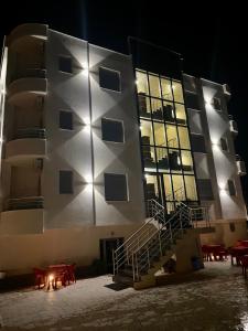 a building with a staircase in front of it at night at AL Hotel in Vlorë