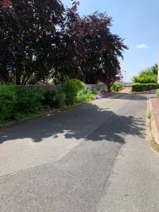 a street with a tree on the side of the road at Appartement aux portes de Paris in Créteil