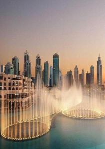 a water fountain in front of a city at Deluxe Studio Address Dubai Mall "The Residence" in Dubai