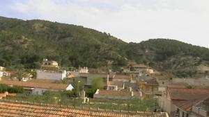a city with houses and a mountain in the background at Hostal Arneva Orihuela in Arneva