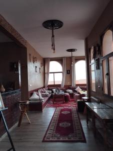 a large living room with couches and a table at DAR AL QANASS IMANE in Midelt