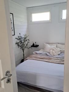 a bedroom with a bed with two towels on it at Attefallshuset in Hyllinge