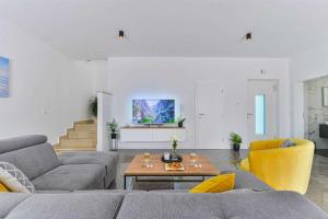 a living room with a couch and a table at Luxury Stone Villa BANOVI with heated pool in Vinjerac