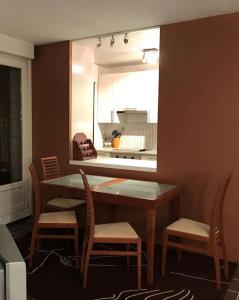 a kitchen with a table and chairs and a mirror at Nid de rêve, vue imprenable sur Paris et terrasse 10m2 in Paris
