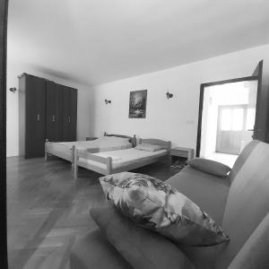 a living room with two beds and a couch at Mir in Petrovac na Moru