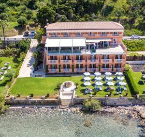 an aerial view of a hotel with tables and umbrellas at Anemona Beach Hotel in Argasi