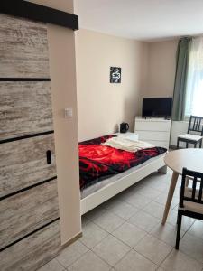 a bedroom with a bed and a table and chairs at Alka in Mielno