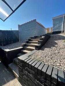a set of stairs next to a brick wall w obiekcie Welsh Getaway Home No 2 - 10 mins to Bike Park Wales w mieście Merthyr Tydfil