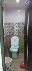 a bathroom with a toilet in a stall at Laxman Guest House in Varanasi