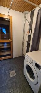 a washer and dryer sitting in a room at Kattohuoneisto keskustassa in Lieksa