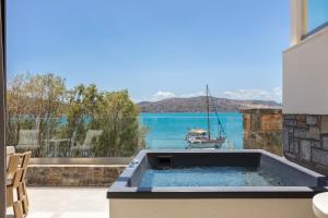 a hot tub with a view of the water at Naiades Boutique Hotel - Adults Only in Elounda