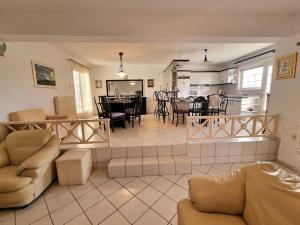 a living room with a couch and a dining room at Heraklion flat , near the aiport in Heraklio