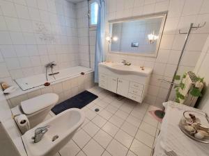 a white bathroom with a sink and a toilet at Heraklion flat , near the aiport in Heraklio