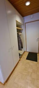 a room with a closet with a door and a rug at Kattohuoneisto keskustassa in Lieksa +5 photos