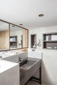 a bathroom with a sink and a large mirror at Paloma Orenda in Side