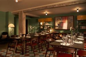 a dining room with a long table and chairs at The Hoxton, Brussels in Brussels +25 photos