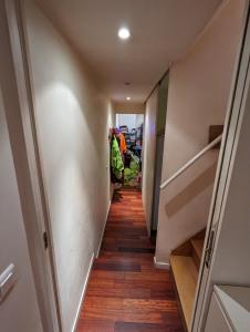 a long hallway with wooden floors and stairs at chambre canal st martin in Paris