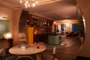 a kitchen and dining room with a table and chairs at The Hoxton, Brussels in Brussels
