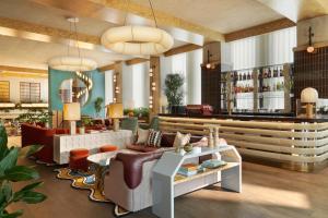 a lobby of a hotel with couches and a bar at The Hoxton, Brussels in Brussels