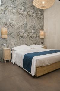 a bedroom with a bed with a floral wallpaper at suite 18 luxury apartments in Bari