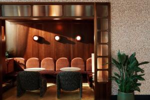 a waiting room with two tables and chairs at The Hoxton, Brussels in Brussels