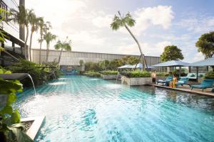 a pool at a resort with a water slide at Padma Hotel Semarang in Semarang