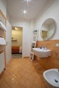 a bathroom with a sink and a mirror at APPARTAMENTI MUSEO 3 in Verona