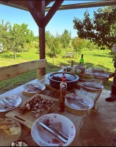 a wooden table with plates of food on it at Mila Vila, Fruška Gora in Irig