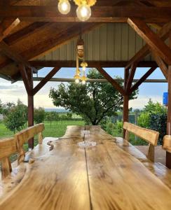 a large wooden table in a pavilion with benches at Mila Vila, Fruška Gora in Irig