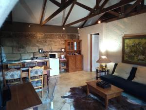 a living room with a couch and a table at VULTURES LODGE in Zastron