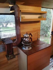 an old stove with a tea kettle on top of it at Karavan in Küçükkuyu