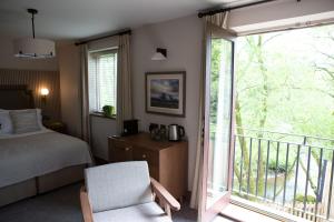 a bedroom with a bed and a balcony at The Tempest Arms in Skipton