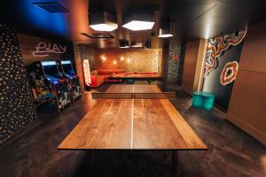 a bowling alley with a table in the middle of a room at Amazing Rooms by FIVE in Zurich