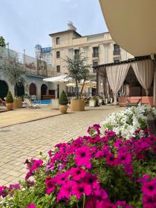 a bunch of pink and white flowers in a courtyard at Arcada Apartments in Odesa