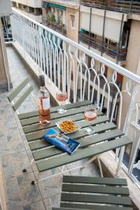 een groene tafel met twee glazen en een fles wijn bij Blue Ark Wanderlust in Athene