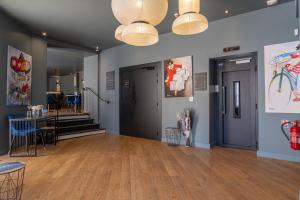 a large room with a wooden floor and blue walls at Boutique Hotel Nice Côte d'azur in Nice