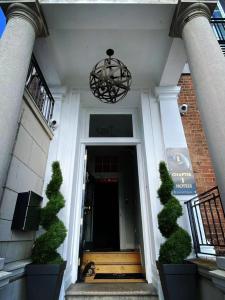 a front door of a building with a chandelier at Chapter 1 Hotels in Weymouth