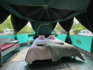 a bedroom with a bed in a tent at Villa Björksten in Loviisa