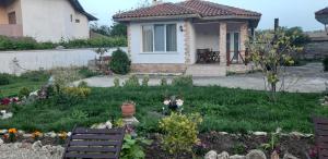 a house with a garden with flowers in the yard at Къща за гости Света Марина in Krapets +92 photos