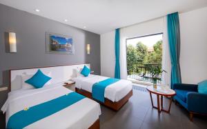 Postel nebo postele na pokoji v ubytování ÊMM Hotel Hoi An + 37 fotografií