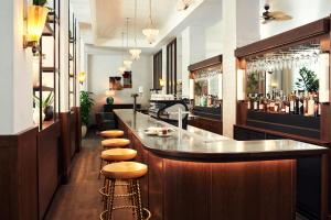 a bar with a row of stools in a restaurant at The Hoxton, Berlin in Berlin