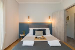 a bedroom with a large bed with a tray on it at Spacious 2 Bedroom Apartment In Koukaki in Athens