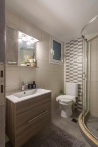 a bathroom with a toilet and a sink and a shower at Spacious 2 Bedroom Apartment In Koukaki in Athens
