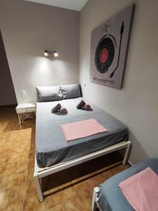 ein Schlafzimmer mit einem Bett mit einem Ziel an der Wand in der Unterkunft Grecos ZERO SKIATHOS in Skiathos-Stadt