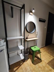 a room with a mirror and a table and a stool at Grecos ZERO SKIATHOS in Skiathos