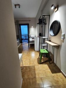 a bathroom with a mirror and a green stool at Grecos ZERO SKIATHOS in Skiathos